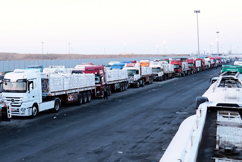 FILE -Trucks carrying humanitarian aids prepare to cross the Egyptian gate of the Rafah crossing, waiting for inspections by Israeli authorities before entering the Gaza Strip, following an agreement between Israel and Hamas on a ceasefire, Oct. 20, 2025. (AP Photo/Mohamed Arafat, File)