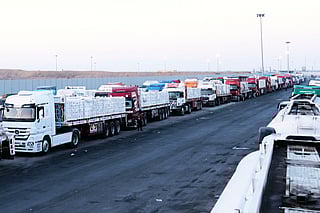 FILE -Trucks carrying humanitarian aids prepare to cross the Egyptian gate of the Rafah crossing, waiting for inspections by Israeli authorities before entering the Gaza Strip, following an agreement between Israel and Hamas on a ceasefire, Oct. 20, 2025. (AP Photo/Mohamed Arafat, File)