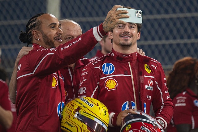 Ferrari's British driver Lewis Hamilton takes a selfie with teammate Charles Leclerc at the Yas Marina Circuit in Abu Dhabi on December 4, 2025.