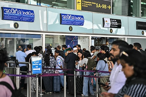 Passengers line up at an Indigo Airlines kiosk at the Kempegowda International Airport. Latest reports indicate that more than 500 IndiGo flights are cancelled nationwide on Friday.