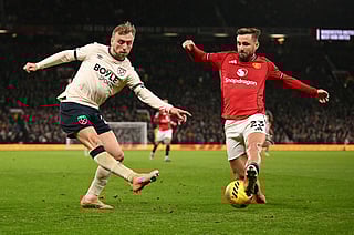 Manchester United's English defender #23 Luke Shaw blocks a cross from West Ham United's English striker #20 Jarrod Bowen during the English Premier League football match between Manchester United and West Ham United at Old Trafford in Manchester, north west England, on December 4, 2025.