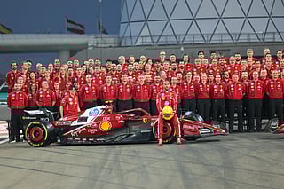 Lewis Hamilton of Ferrari and his team pose for a group photograph at the Formula 1 Etihad Airways Abu Dhabi Grand Prix 2025 at the Yas Marina Circuit on Thursday. 