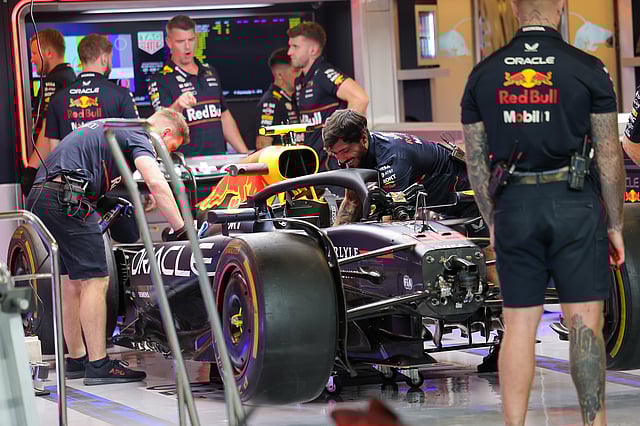 Support staff working on a Red Bull Racing car at the Abu Dhabi Grand Prix 2025.