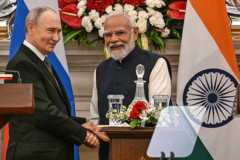 Russia's President Vladimir Putin (L) speaks with India's Prime Minister Narendra Modi after their joint press statements at the Hyderabad House in New Delhi on December 5, 2025.