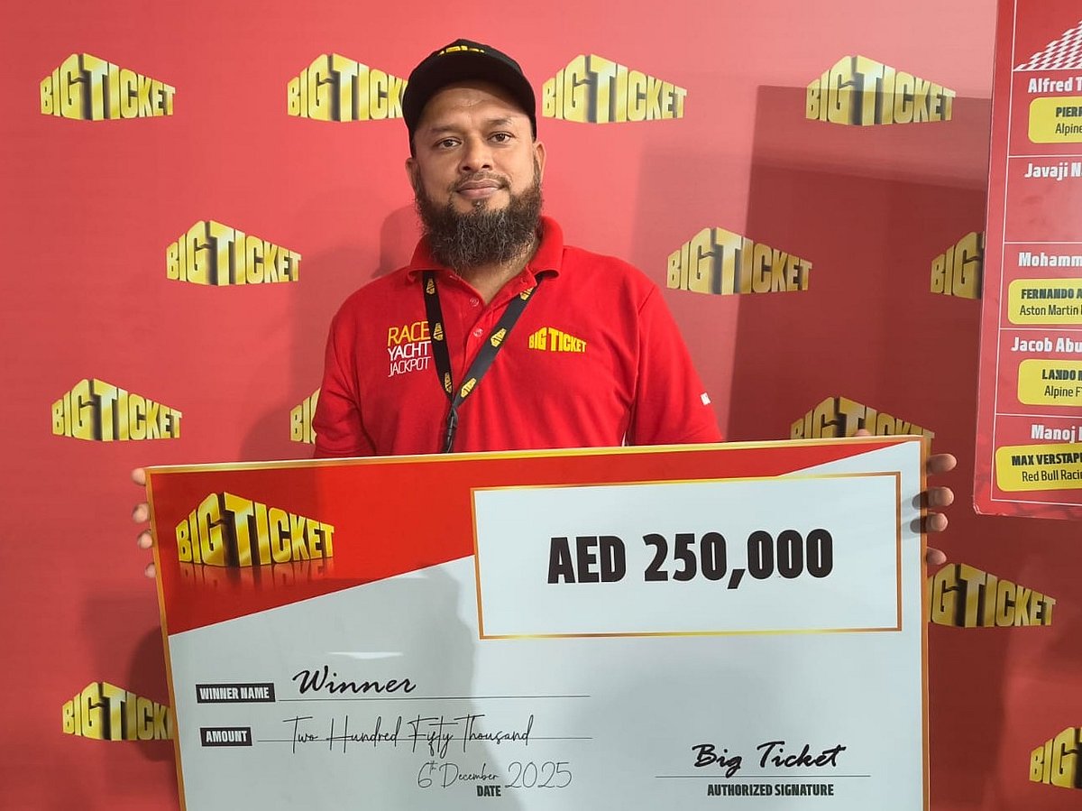 Muhammad Kabir Sarkar proudly displays his winning cheque.