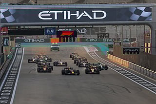 Max Verstappen of Red Bull and Lando Norris of McLaren leads the pack at start of Formula 1 Etihad Airways Abu Dhabi Grand Prix 2025.