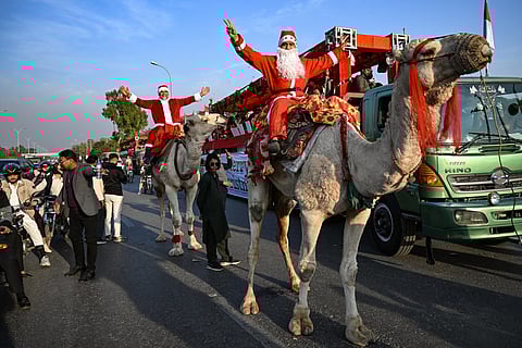 Santas ski, race and ride camels as Christmas spirit spreads worldwide