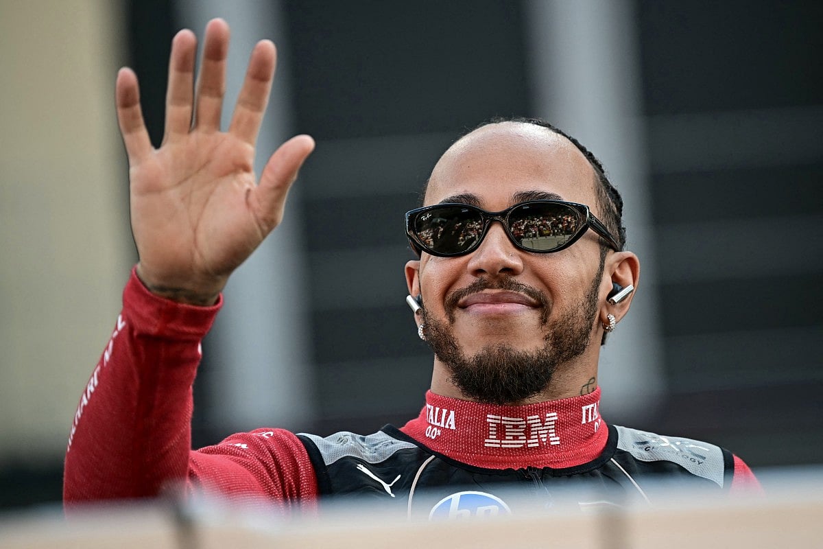 Ferrari's British driver Lewis Hamilton arrives for a group photo with other drivers ahead of the Abu Dhabi Formula One Grand Prix at the Yas Marina Circuit in Abu Dhabi on December 7, 2025.
