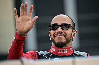 Ferrari's British driver Lewis Hamilton arrives for a group photo with other drivers ahead of the Abu Dhabi Formula One Grand Prix at the Yas Marina Circuit in Abu Dhabi on December 7, 2025.