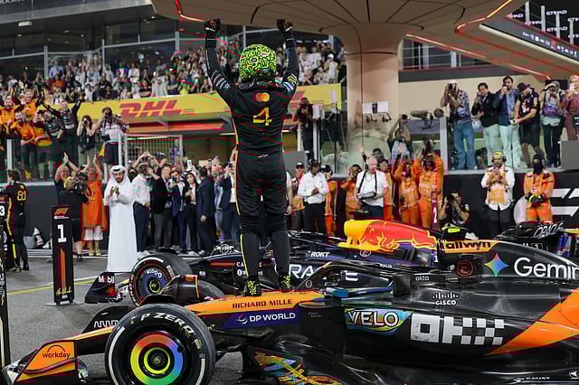 McLaren's Lando Norris celerbrates on his car at the Formula 1 Etihad Airways Abu Dhabi Grand Prix 2025. 