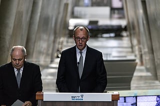 German Chancellor Friedrich Merz, right, makes a statement next to Dani Dayan, chairman of the Yad Vashem Holocaust Memorial Museum in Jerusalem, Sunday, Dec. 7, 2025. (John Wessels, Pool Photo via AP)