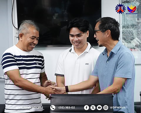 Department of Public Works and Highways (DPWH) Secretary Vince Dizon (right) meets with the newly-hired civil engineer Dave Rusty Recososa (center) and his father Edwin (left) at the DPWH Davao Regional Office.