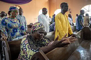 Worshippers pray at the Evangelical Church Winning All (ECWA) during a prayer called by the Christian Association of Nigeria (CAN) in Minna on December 7, 2025.