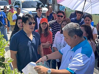 Actor-turned-Senator Ramon "Bong" Revilla JR (in navy blue shirt) visits an infrastructure project with Henry Alcantara (right) in Bulacan province, north of Manila.
