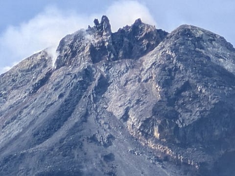 Close-up photograph of the Mayon Volcano summit reveal new spines of dark lava.