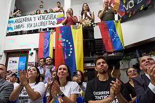 People applaud while watching the ceremony of the Nobel Peace Prize for Venezuelan opposition leader Maria Corina Machado in Norway, during a live viewing in Buenos Aires, Argentina, Wednesday, Dec. 10, 2025. 