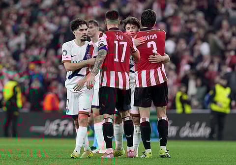 Paris Saint-Germain's Portuguese midfielder #17 Vitinha greets Athletic Bilbao's Spanish defender #17 Yuri Berchiche at the end of the UEFA Champions League league phase day 6 football match between Athletic Club Bilbao and Paris Saint-Germain (PSG) at San Mames Stadium in Bilbao on December 10, 2025.