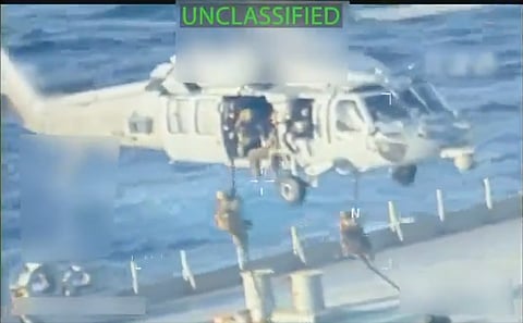 US forces rappelling from a helicopter onto a seized oil tanker, underscoring the Trump administration's intensified campaign against Venezuela's Maduro, indicted on US narcoterrorism charges.