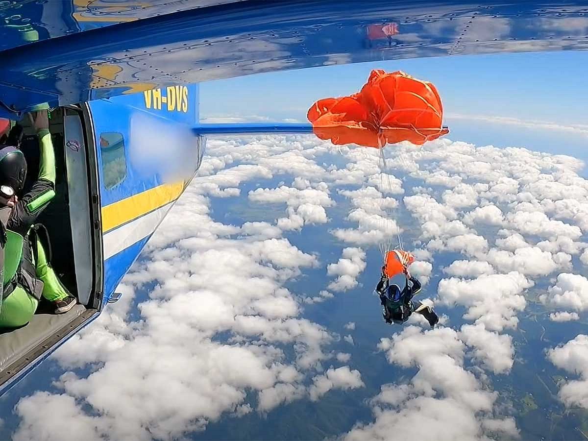 Dramatic video shows parachute entangled with aircraft; jumper escapes with minor injuries.