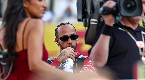 Ferrari's British driver Lewis Hamilton looks on ahead of the during the Abu Dhabi Formula One Grand Prix at the Yas Marina Circuit in Abu Dhabi on December 7, 2025.