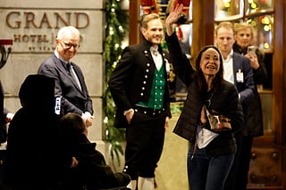 Nobel peace laureate Maria Corina Machado (R) waves to supporters gathered outside the Grand Hotel in Oslo, Norway, in the early hours of December 11, 2025.