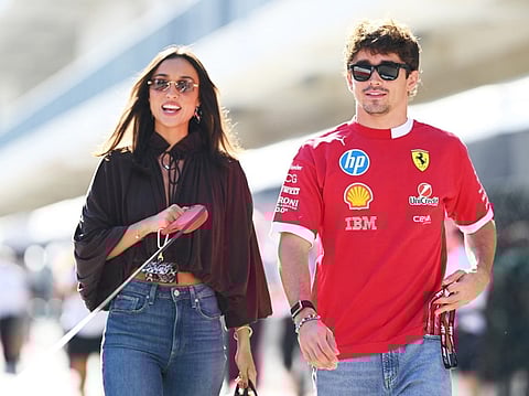Charles Leclerc of Monaco and Scuderia Ferrari and Alexandra Saint Mleux arrive in the Paddock prior to practice ahead of the F1 Grand Prix of United States 