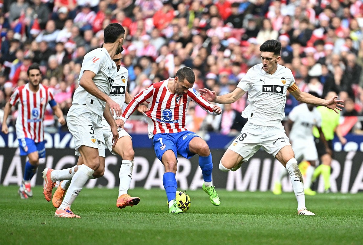 Atletico Madrid's French forward #07 Antoine Griezmann fights for the ball during the Spanish league football match between Club Atletico de Madrid and Valencia CF at Metropolitano Stadium in Madrid on December 13, 2025.