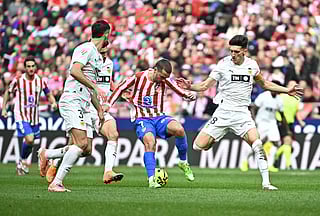 Atletico Madrid's French forward #07 Antoine Griezmann fights for the ball during the Spanish league football match between Club Atletico de Madrid and Valencia CF at Metropolitano Stadium in Madrid on December 13, 2025.