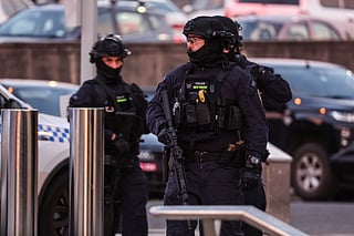 Armed police work at the scene after a shooting incident at Bondi Beach in Sydney on December 14, 2025.