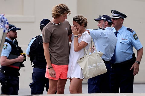 Residents mourn as they lay flowers at the entrance of the Bondi Pavilion in Sydney on December 15, 2025, a day after a shooting at the popular seaside spot.