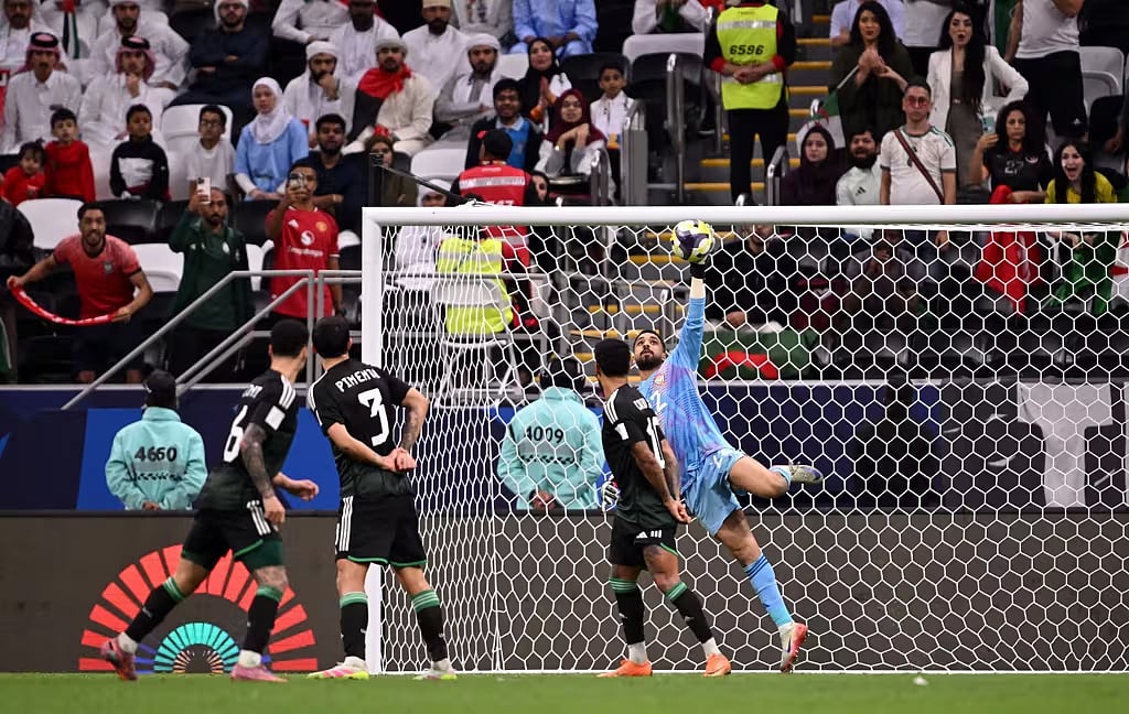 UAE goalkeeper Hamad Al Meqbaali makes a late save against Algeria.