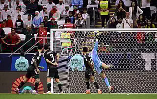 UAE goalkeeper Hamad Al Meqbaali makes a late save against Algeria.