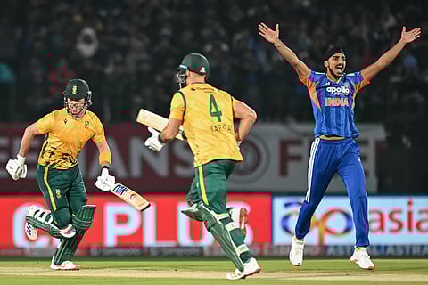 India's Arshdeep Singh (R) unsuccessfully appeals for leg before wicket (LBW) against South Africa's Dewald Brevis (L) during the third Twenty20 international cricket match between India and South Africa at the Himachal Pradesh Cricket Association Stadium in Dharamsala on December 14, 2025.