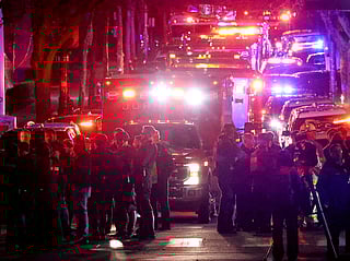 Emergency personnel gather on Waterman Street at Brown University in Providence, R.I., on Saturday, Dec. 13, 2025, during the investigation of a shooting. (AP Photo/Mark Stockwell)