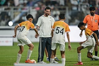 Argentina's footballer Lionel Messi (2L) plays football with children during his GOAT Tour at the Wankhede Stadium in Mumbai on December 14, 2025.