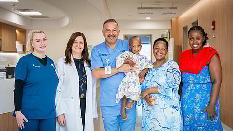 Dr Dalia Belsha (second left), Consultant Paediatric Gastroenterologist, and Dr Ahmad Alsweed (centre), Consultant Paediatric Surgeon, with the patient and his family