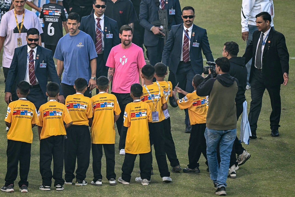 Argentina's footballer Lionel Messi (C) arrives to attend an event during his GOAT Tour at the Arun Jaitley Stadium in New Delhi on December 15, 2025.
