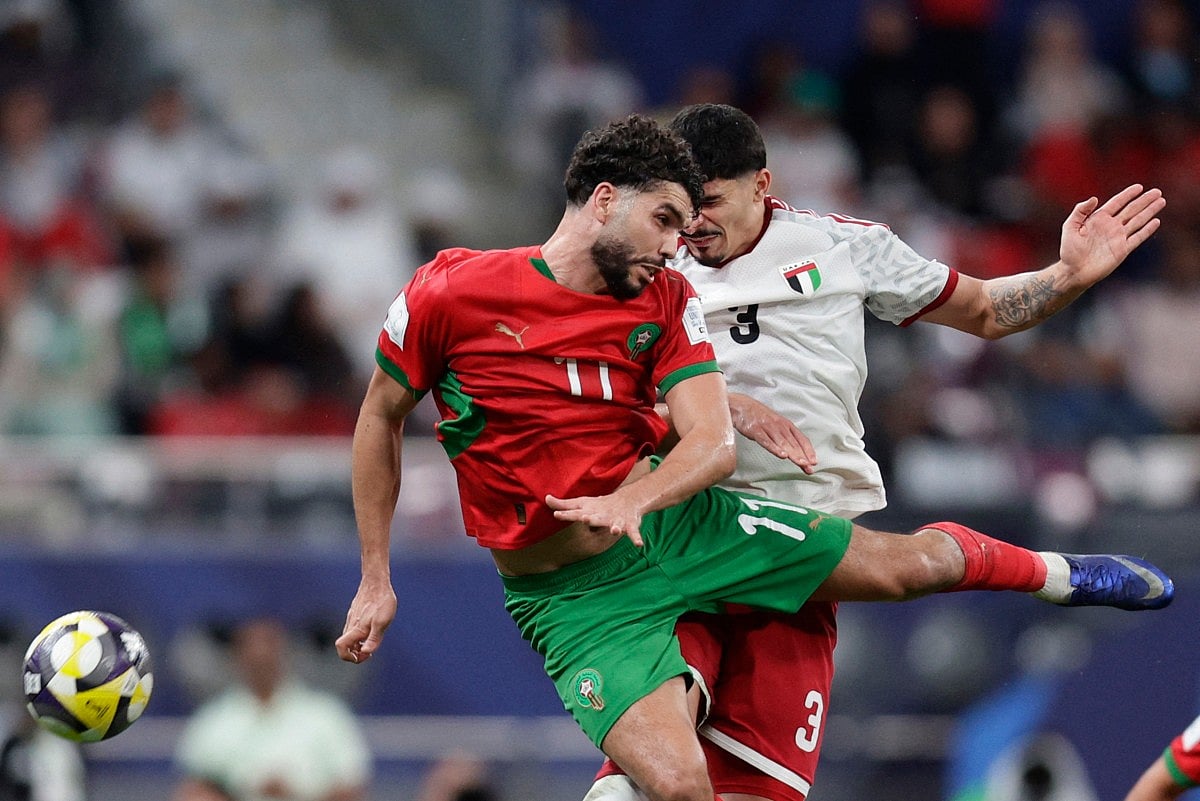 Morocco's forward #11 Oualid Azaro (front) is challenged by UAE’s defender #3 Lucas Pimenta (back) during the FIFA Arab Cup 2025 semi-final football match between Morocco and the United Arab Emirates at the Khalifa International Stadium in Al-Rayyan on December 15, 2025.