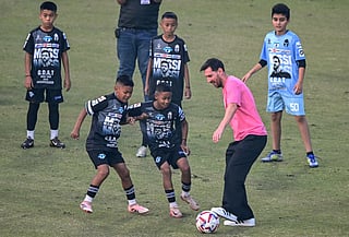 Argentina's footballer Lionel Messi plays football with children during his GOAT Tour at the Arun Jaitley Stadium in New Delhi on December 15, 2025.