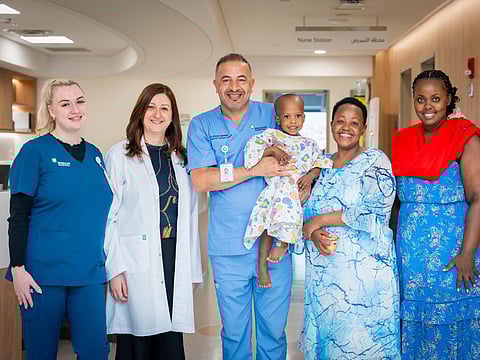 Dr Dalia Belsha (second left), Consultant Paediatric Gastroenterologist, and Dr Ahmad Alsweed (centre), Consultant Paediatric Surgeon, with the patient and his family