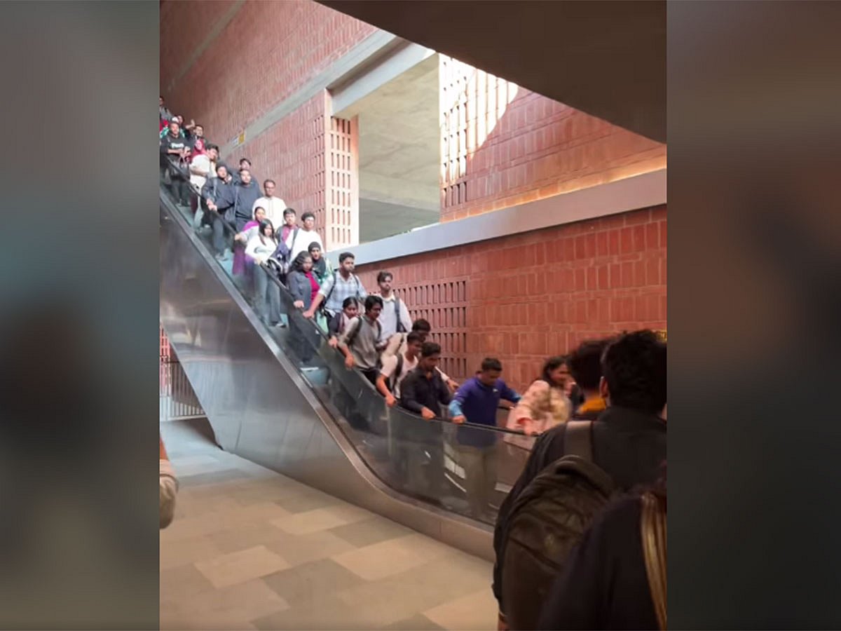 The footage shows students struggling to keep their balance as the escalator abruptly speeds up.