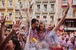 Revellers cool off with water thrown from balconies at the start of nine days of uninterrupted partying during the famed running of the bulls festival in Pamplona, Spain, on July 6.