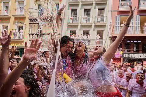 Revellers cool off with water thrown from balconies at the start of nine days of uninterrupted partying during the famed running of the bulls festival in Pamplona, Spain, on July 6.