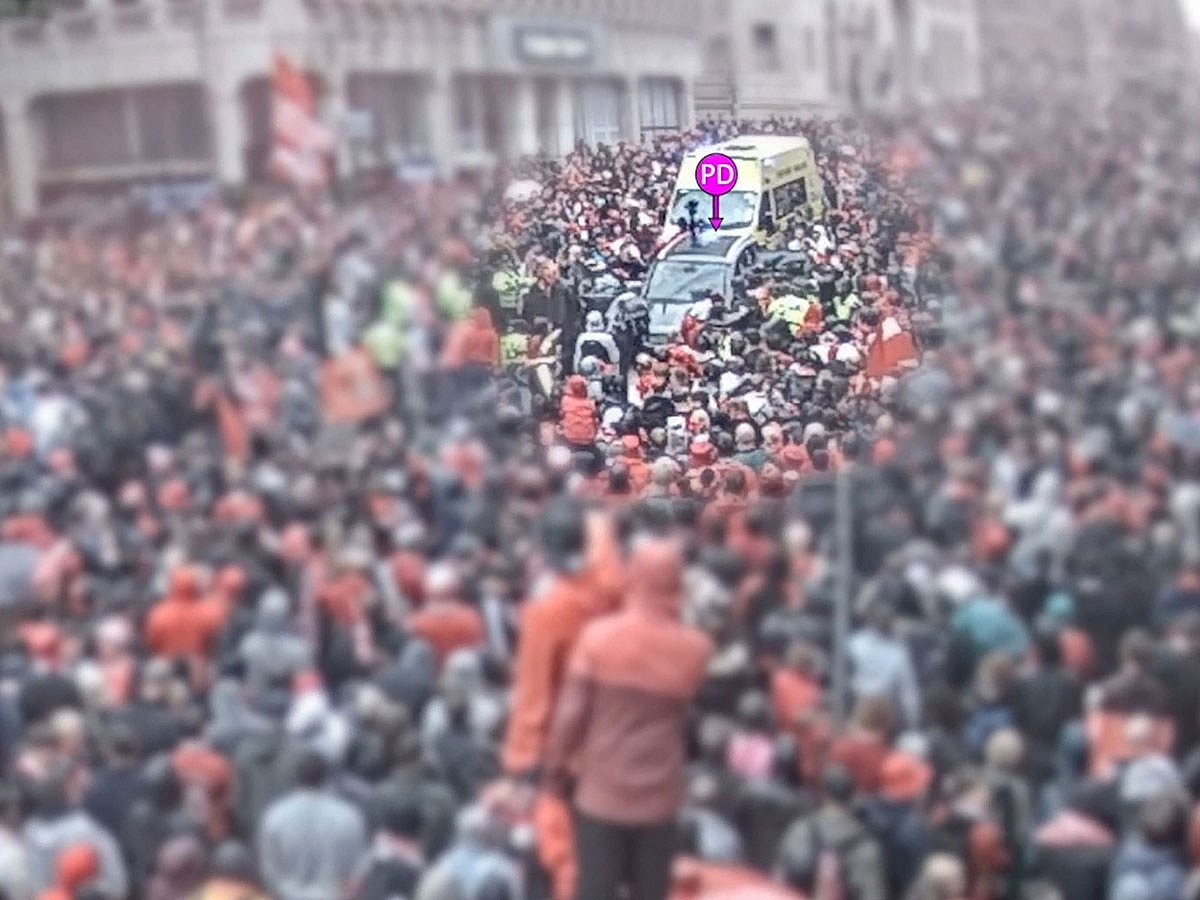 A car (c) driven by Paul Doyle - marked by police as "PD" - as crowds gather to watch an open-top bus victory parade for Liverpool's Premier League trophy parade.