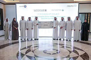 Judge Abdulqader Mousa Mohammed, Chairman of the Rental Disputes Center, receiving donation cheque from Dr Ahmed Thlak, General Director of Tarahum Charity Foundation