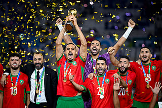 Morroco's players celebrate with the trophy after winning the FIFA Arab Cup 2025 final football match between Jordan and Morocco at the Lusail Stadium Stadium, in Lusail on December 18, 2025.