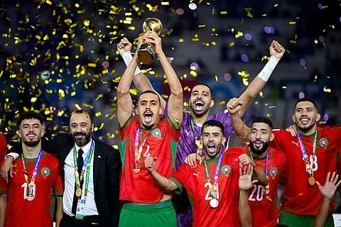 Morroco's players celebrate with the trophy after winning the FIFA Arab Cup 2025 final football match between Jordan and Morocco at the Lusail Stadium Stadium, in Lusail on December 18, 2025.