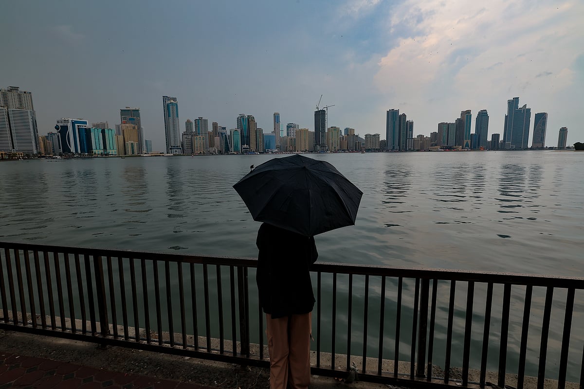 Residents caught in the rain at Al Majaz in Sharjah on Thursday.