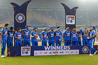 India's captain Suryakumar Yadav (R), along with team players, celebrates with the trophy after winning the series against South Africa at the end of the fifth Twenty20 international cricket match at the Narendra Modi Stadium in Ahmedabad on December 19, 2025.