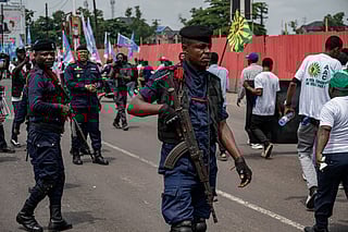 Police officers patrol as demonstrators take part in the peaceful march organised by the Sacred Union of the Nation in Kinshasa on December 19, 2025 to express support for Congolese institutions, the Armed Forces of the Democratic Republic of Congo (FARDC) and the Wazalendo, and to denounce the Rwandan aggression in eastern DR Congo, and affirm attachment to national sovereignty.